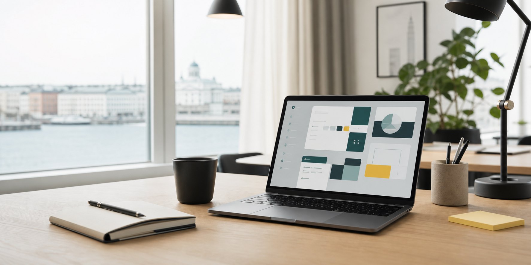 A calm workspace with a laptop showing app interface concepts in Helsinki.